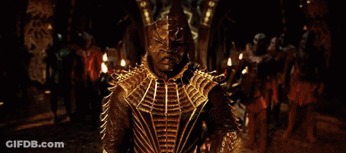 Man In Gold Costume Standing In Front Of Crowd GIF