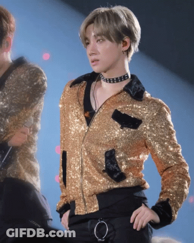 Man In Gold Jacket And Choker On Stage GIF
