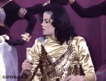 Man In Gold Shirt With Group GIF