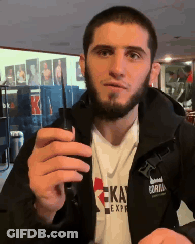 Man In Gorilla Express Jacket Holding Cell Phone GIF