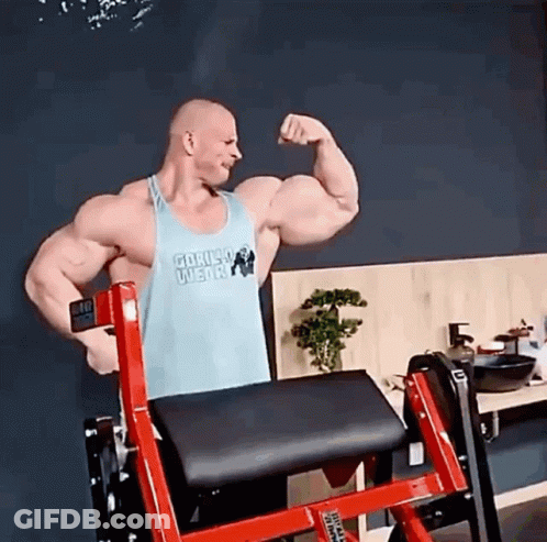 Man In Gorilla Wear Tank Top Flexing Biceps GIF
