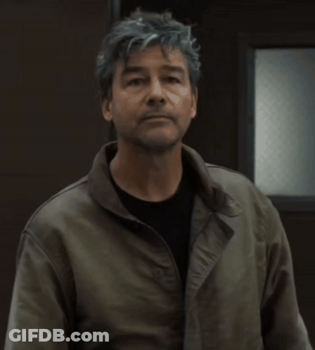 Man In Gray Hair And Black Shirt Wearing Green Jacket GIF