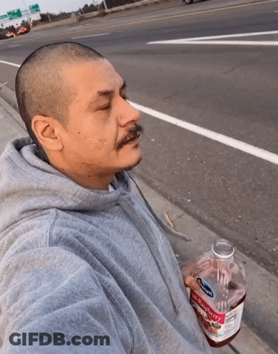 Man In Gray Hoodie Holding Strawberry Juice GIF