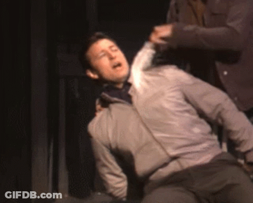 Man In Gray Jacket Lying On Floor GIF