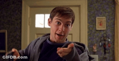 Man In Gray Jacket Pointing At Camera GIF