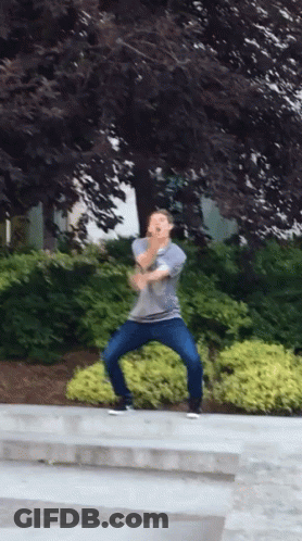 Man In Gray Shirt And Blue Jeans Dancing GIF