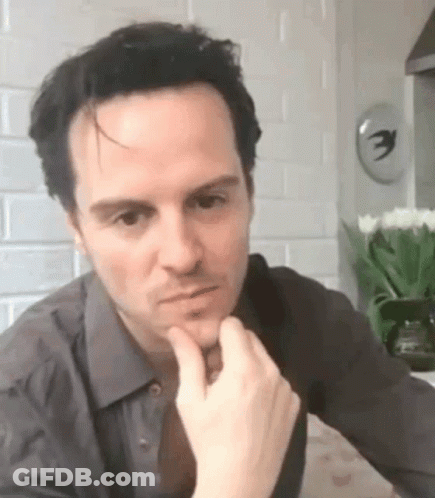 Man In Gray Shirt And Tie Sitting GIF