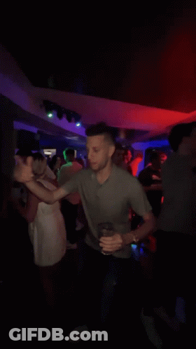 Man In Gray Shirt Dancing In Crowd GIF
