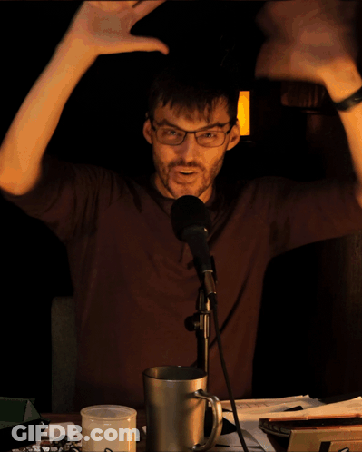 Man In Gray Shirt Held By Another Man's Hand GIF