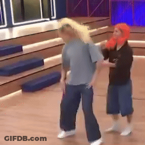 Man In Gray Shirt Next To Woman In Orange Hat GIF