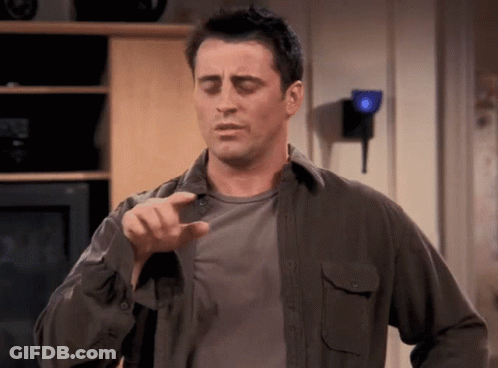 Man In Gray Shirt Pointing At Camera GIF