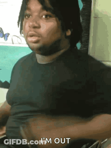 Man In Gray Shirt Sitting With Arms Crossed Says Yup GIF