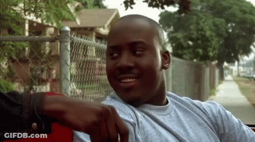 Man In Gray Shirt Smiling And Pointing At Camera GIF