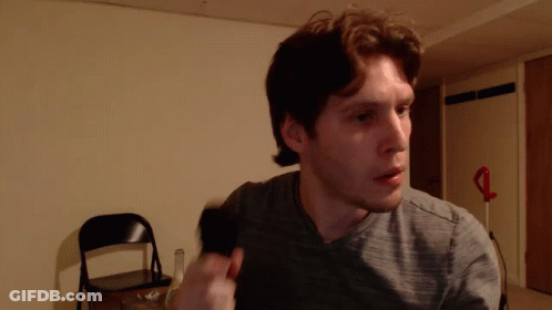 Man In Gray Shirt Standing In Room GIF