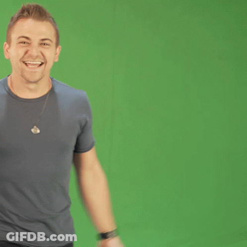 Man In Gray Shirt With Necklace Smiling GIF