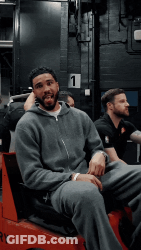 Man In Gray Sweatshirt In Red Vehicle Number 1 GIF
