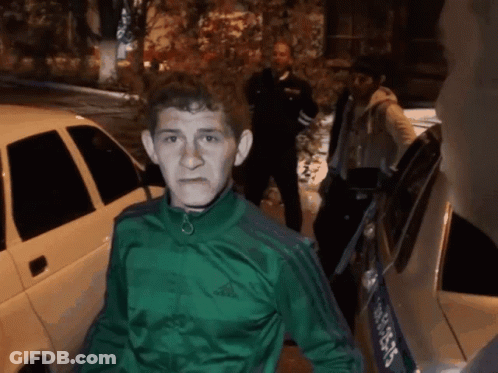 Man In Green Adidas Jacket Standing In Front Of Car GIF
