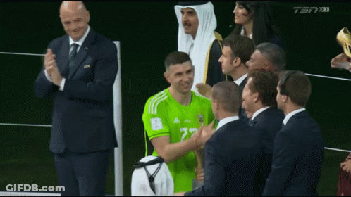 Man In Green Adidas Jersey Congratulated By Group GIF