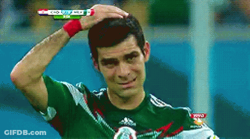 Man In Green Adidas Shirt Holding Head GIF