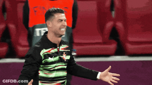 Man In Green And Black Shirt With Red T GIF