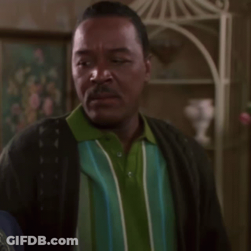 Man In Green And Blue Striped Shirt And Black Cardigan GIF