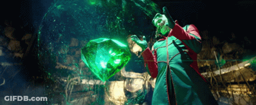 Man In Green And Red Coat Holding Green Cube GIF