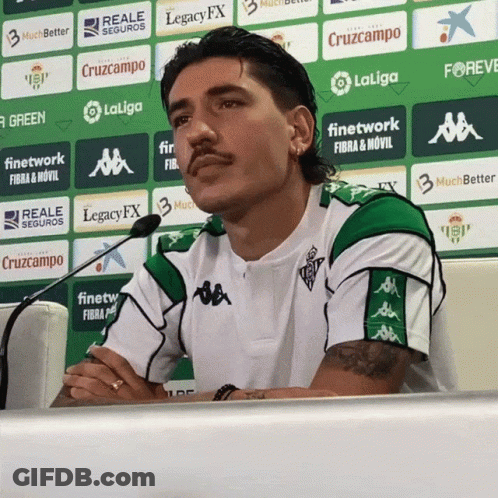 Man In Green And White Shirt In Front Of LaLiga Logo Wall GIF