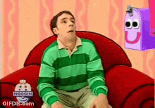 Man In Green And White Striped Shirt Sitting In Red Chair GIF