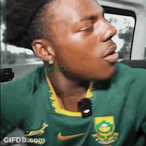 Man In Green And Yellow Nike Shirt With Open Mouth In Car GIF