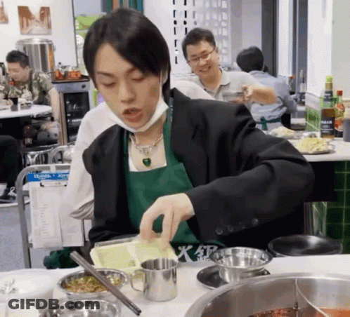 Man In Green Apron And Black Jacket Preparing Food GIF