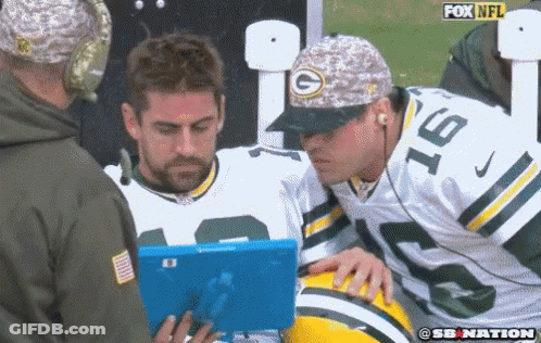 Man In Green Bay Packers Hat Looking At Blue Tablet GIF