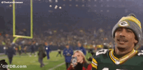 Man In Green Bay Packers Jersey And Beanie Arms In Air GIF