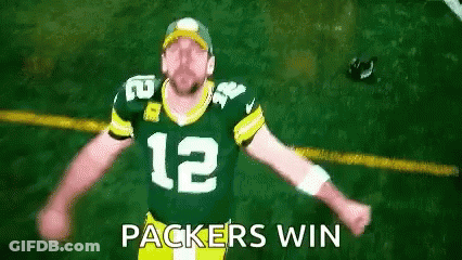 Man In Green Bay Packers Jersey Arms Outstretched Saying Packers Win GIF