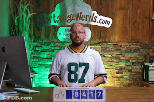Man In Green Bay Packers Jersey In Front Of Mortgage Nerds Sign GIF
