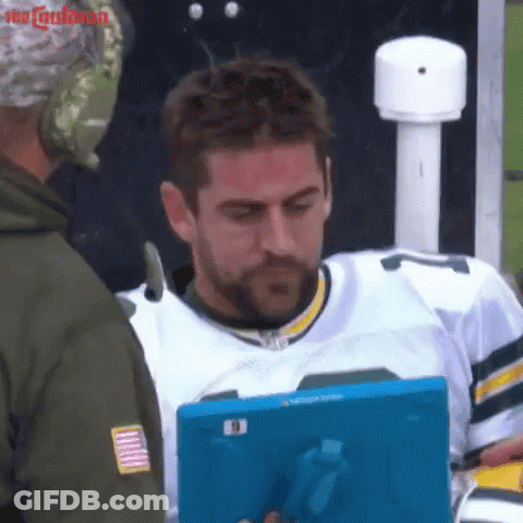 Man In Green Bay Packers Jersey Looking At Tablet GIF
