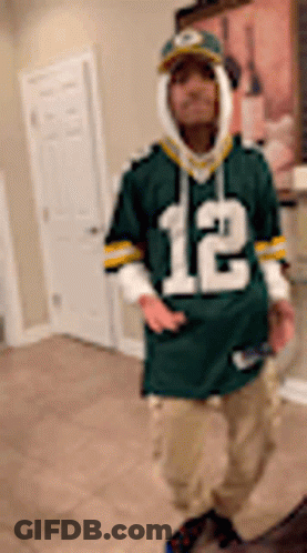 Man In Green Bay Packers Jersey Standing In Room GIF