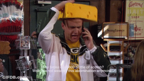 Man In Green Bay Packers Shirt Talking On Phone GIF