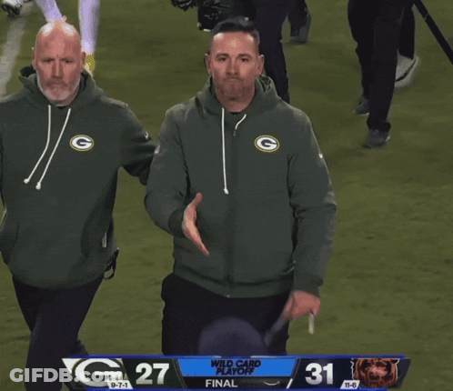 Man In Green Bay Packers Sweatshirt Next To Bears Jersey GIF