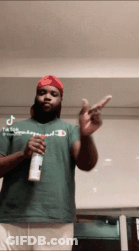 Man In Green Champion Shirt Holding Spray Can GIF