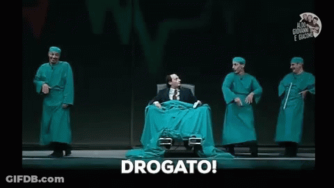 Man In Green Cloth Chair On Stage With Surgical Gowns GIF