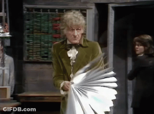 Man In Green Coat Holding Fan GIF