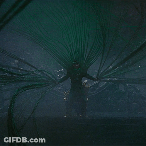 Man In Green Costume Surrounded By Green Wires GIF