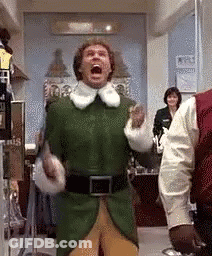 Man In Green Elf Costume Screaming In Room With Other People GIF