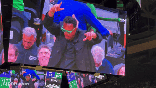 Man In Green Glasses Dancing In Front Of Scoreboard 85 102 GIF
