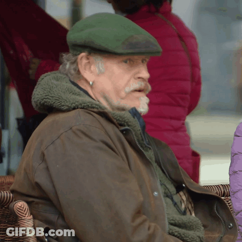 Man In Green Hat And Brown Jacket GIF