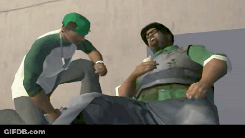 Man In Green Hat Talking To Man In Green Vest GIF
