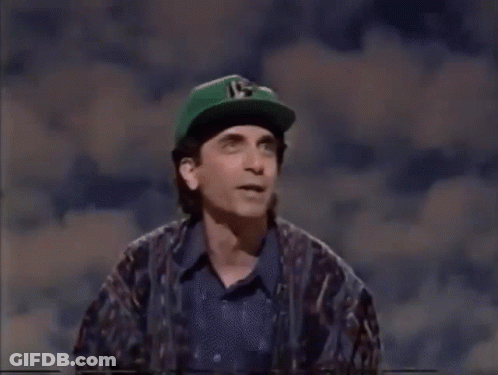 Man In Green Hat With Number 15 Next To Woman GIF