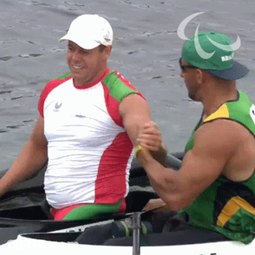 Man In Green Hat With Paralympic Shaking Hands GIF