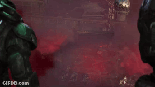Man In Green Helmet In Front Of Red Building GIF