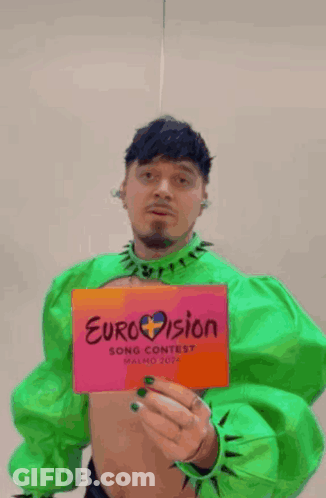 Man In Green Holding Eurovision Sign GIF